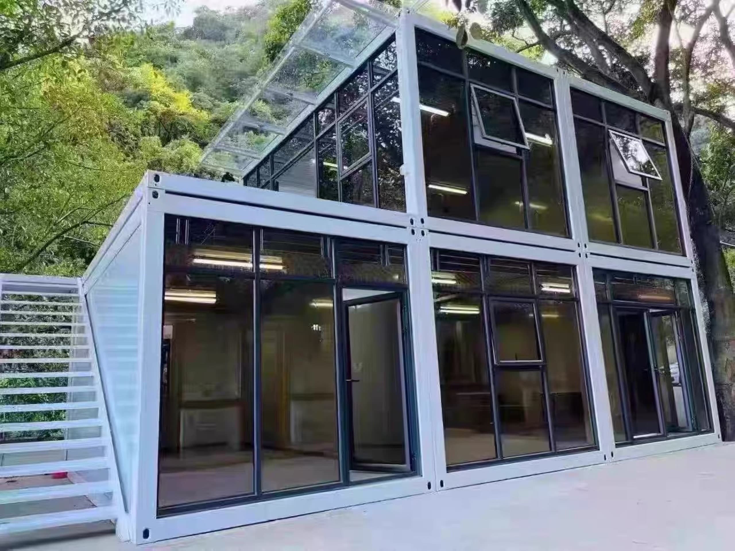 Văn phòng container hai tầng mặt kính khung đen, cầu thang thép bên ngoài